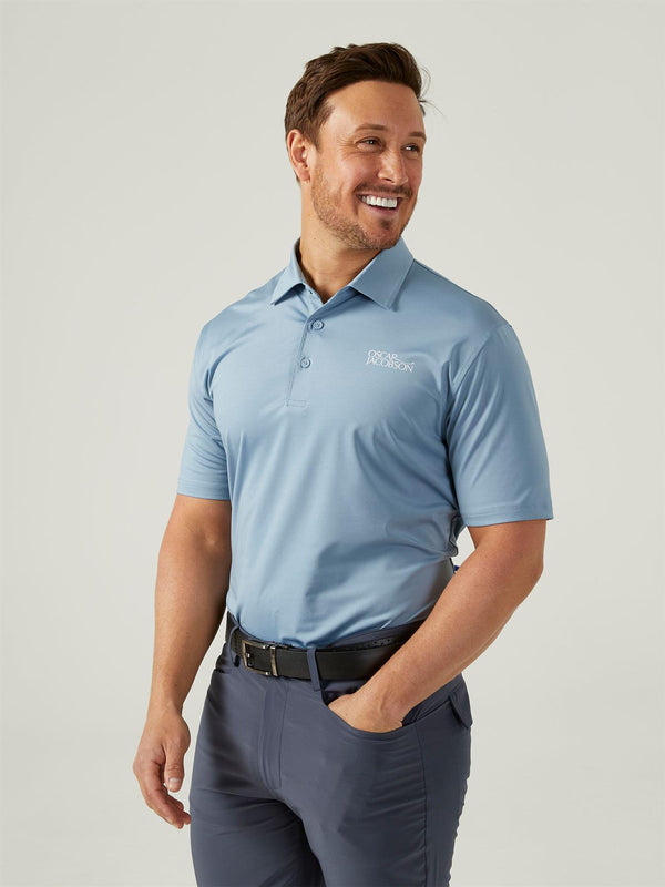 Ocar Jacobson Man wearing a light blue polo shirt with a logo on a plain background