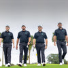 Southern Guards GC players walking the fairway in black Oscar Jacobson kit with the green rhino crest